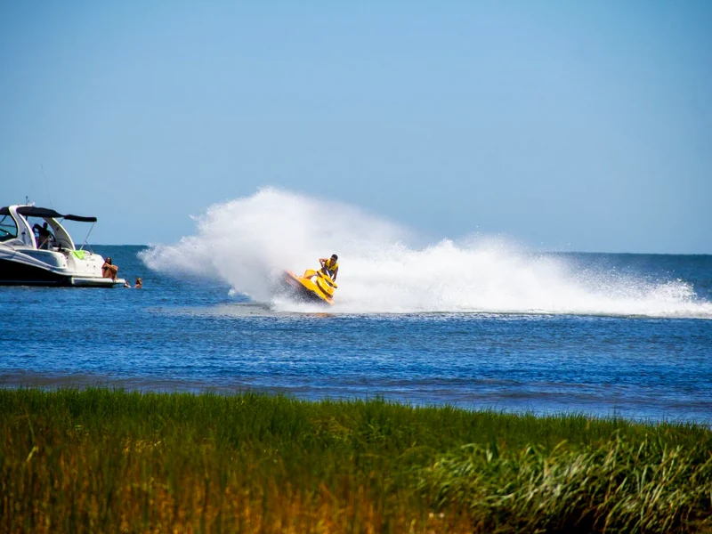 15-minute jet ski blast in Ras Al Khaimah — rider carving a wall of spray on the Arabian Gulf