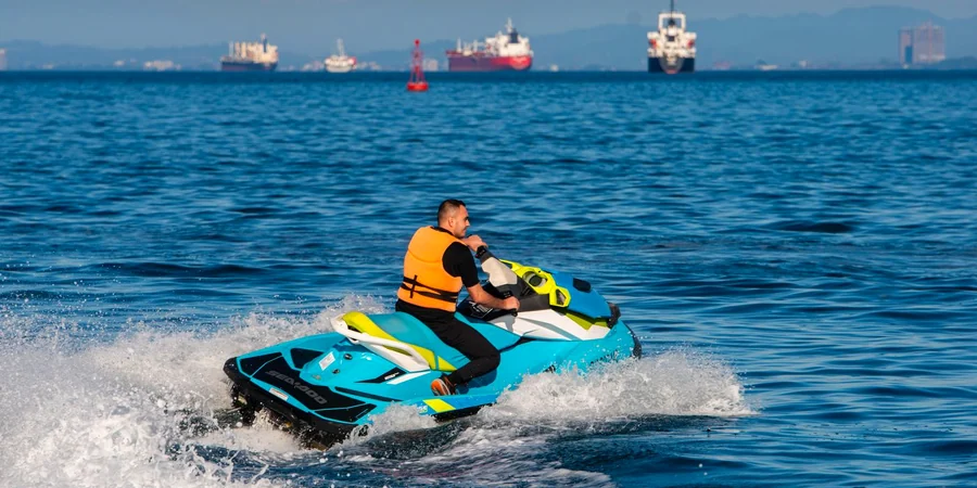 Beginner jet ski rider with a life jacket on calm water in Ras Al Khaimah