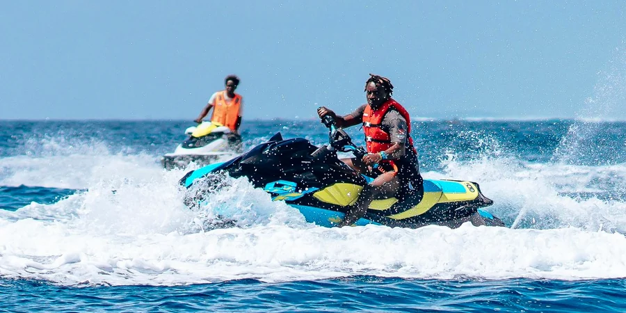 Two riders sharing a jet ski in Ras Al Khaimah on a sunny day
